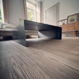 Coffee table with raw metal steel leaf.