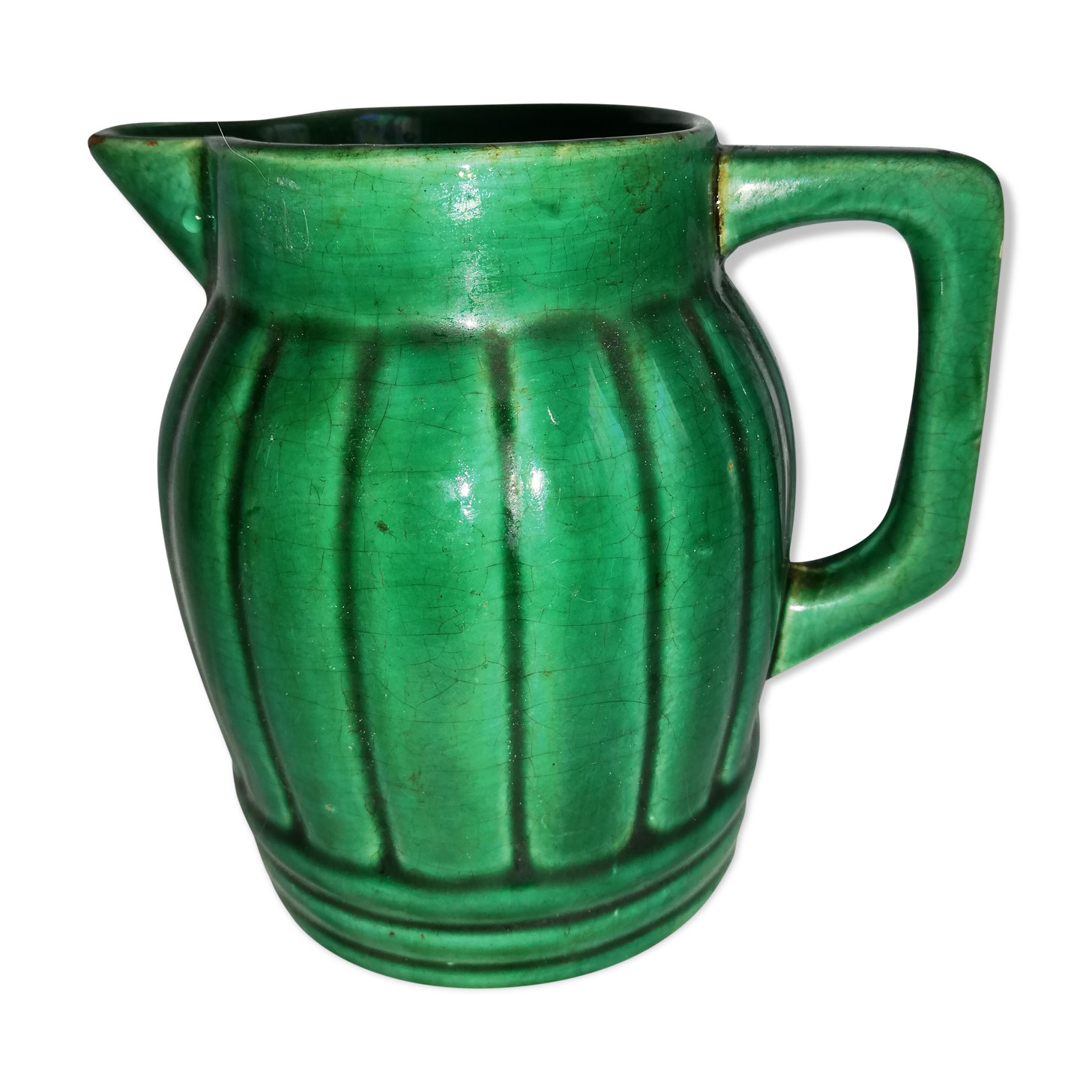 Old green pitcher in dabbling
