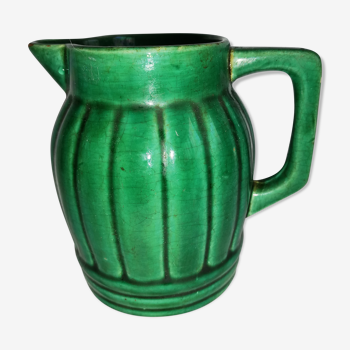 Old green pitcher in dabbling