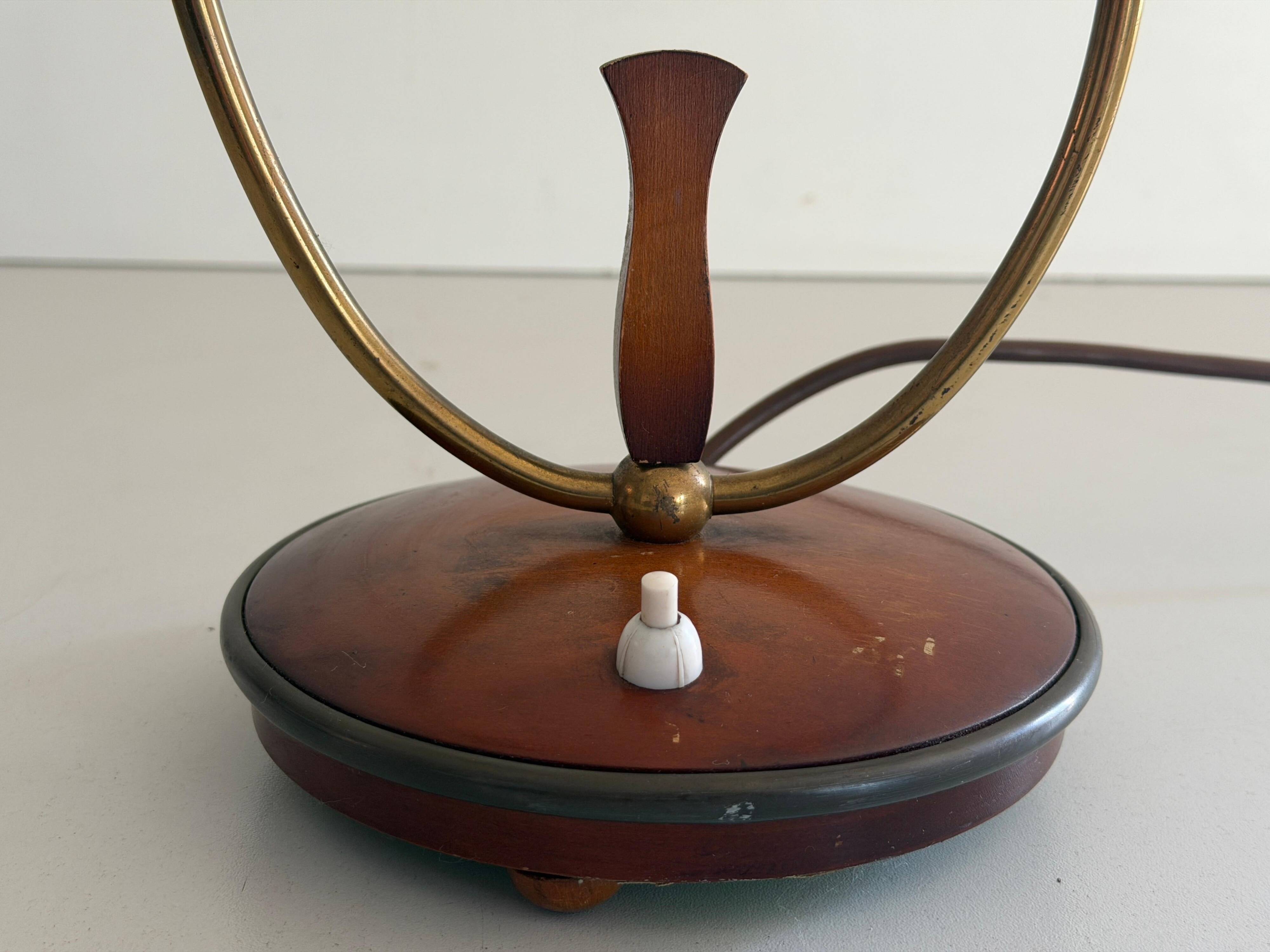 Simple double-headed table lamp in wood and brass, 1960s, Germany.