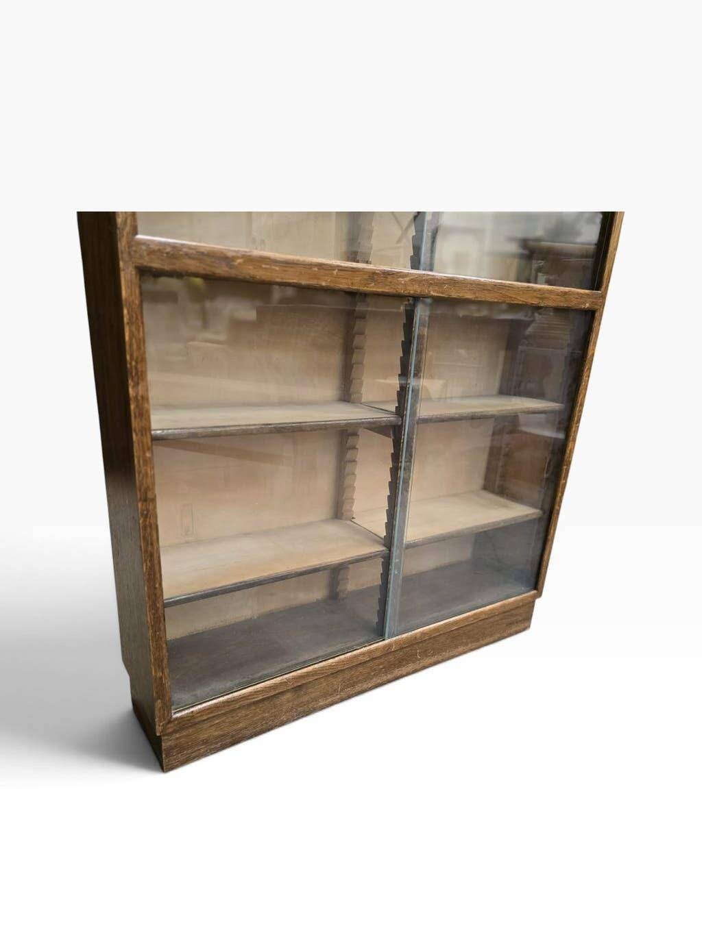 Vintage shallow wooden display shelf with sliding glass doors.