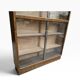 Vintage shallow wooden display shelf with sliding glass doors.
