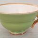 Coffee cup and under cup in green Salins earthenware and vintage gold net
