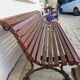 Public bench in wooden slats and cast iron legs