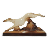Beige and brown ceramic representing a “Greyhound/vintage 1930