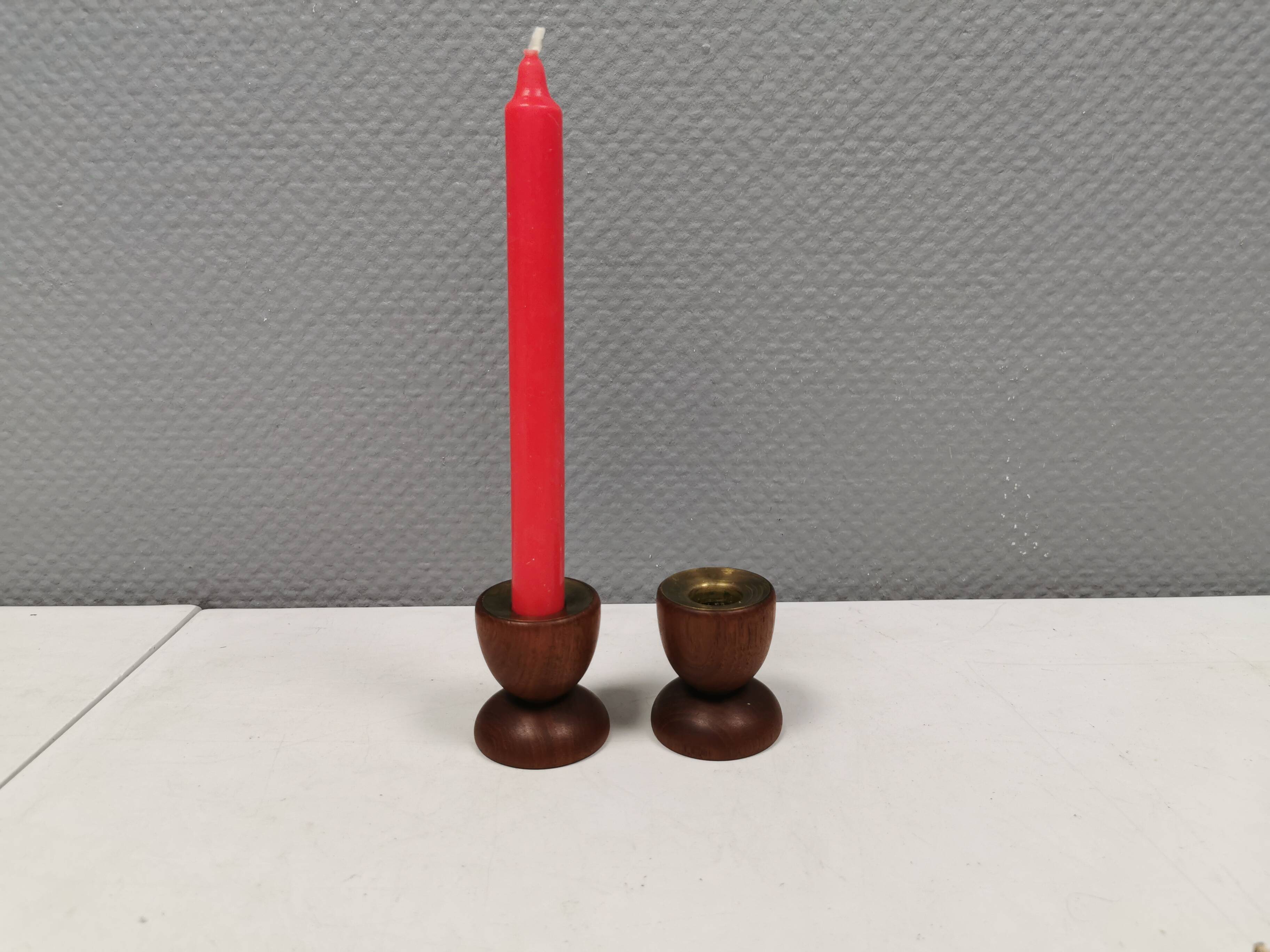 Two beautiful teak candle holders with brass inserts.