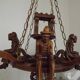French vintage Breton chandelier with hand-carved figures, well, and lantern lights.