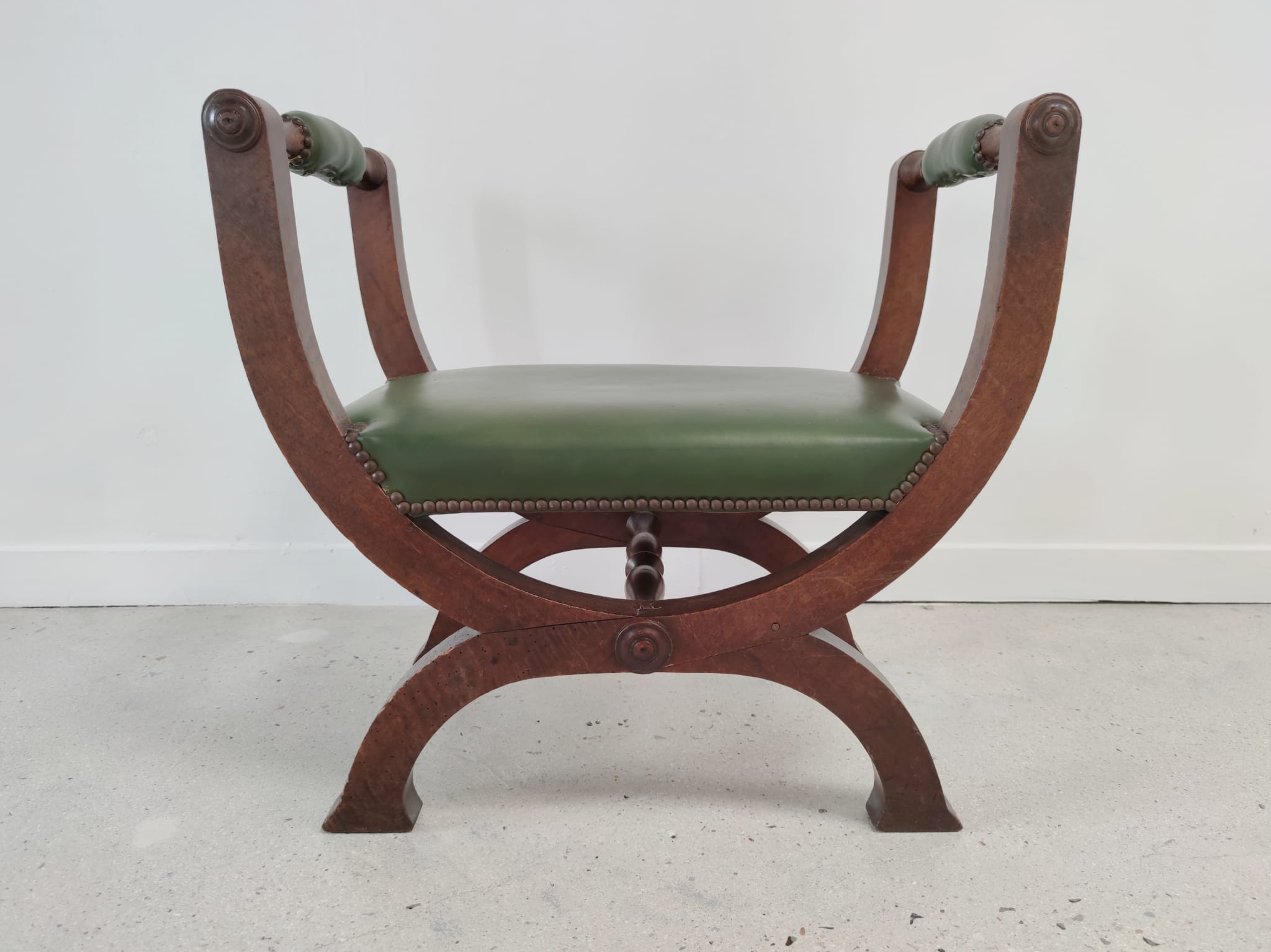 Green curule armchair