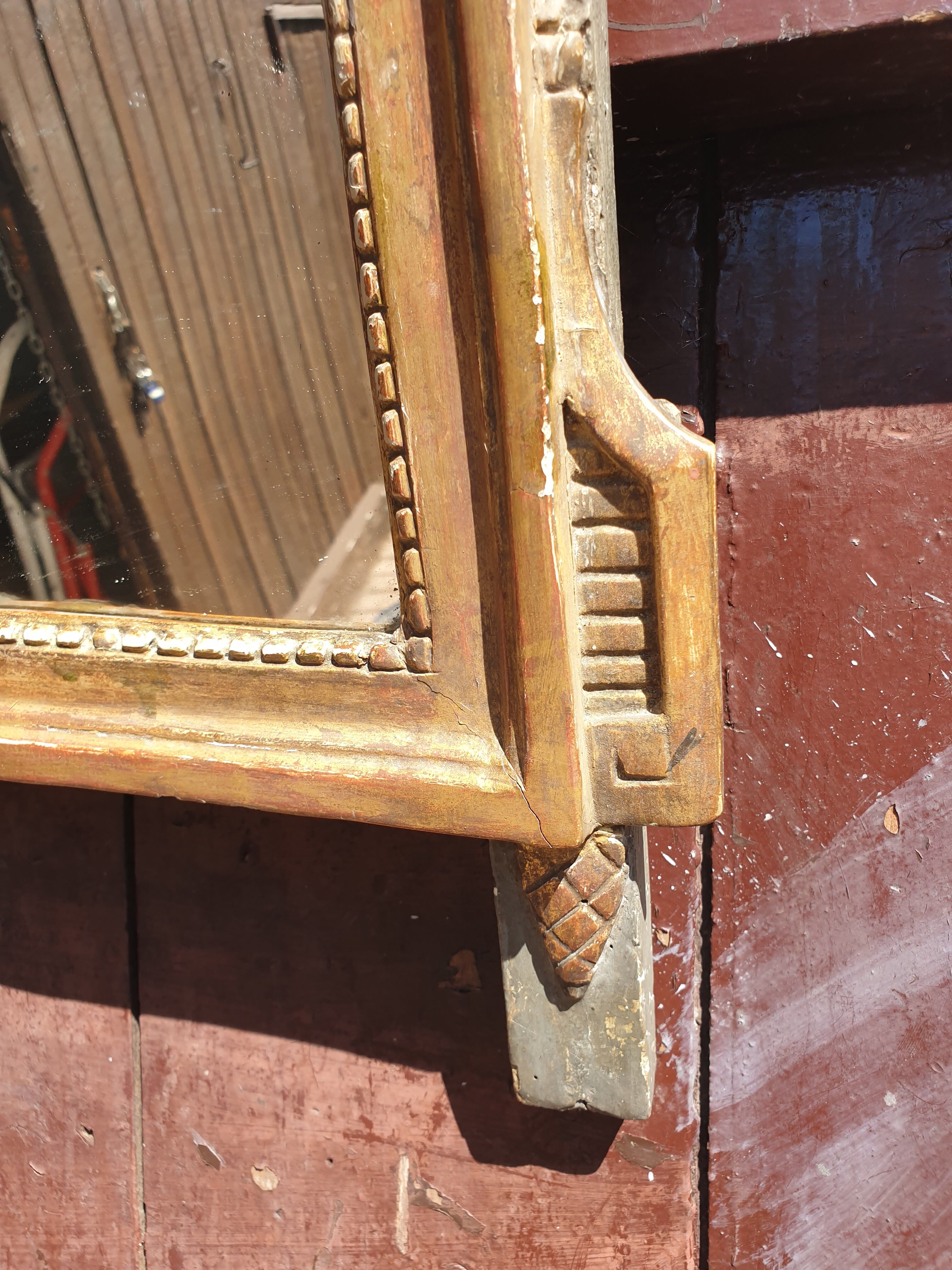Old mirror in carved and gilded wood