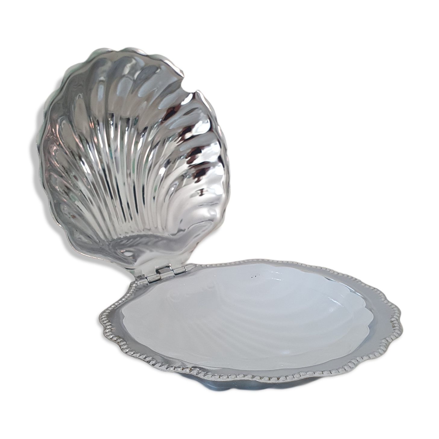 Scallop shell butter dish in stainless steel with its white glass saucer.