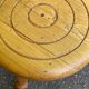 Vintage low tripod stool with carved light oak legs.