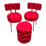 Red furry chairs and pouffe