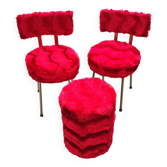 Red furry chairs and pouffe