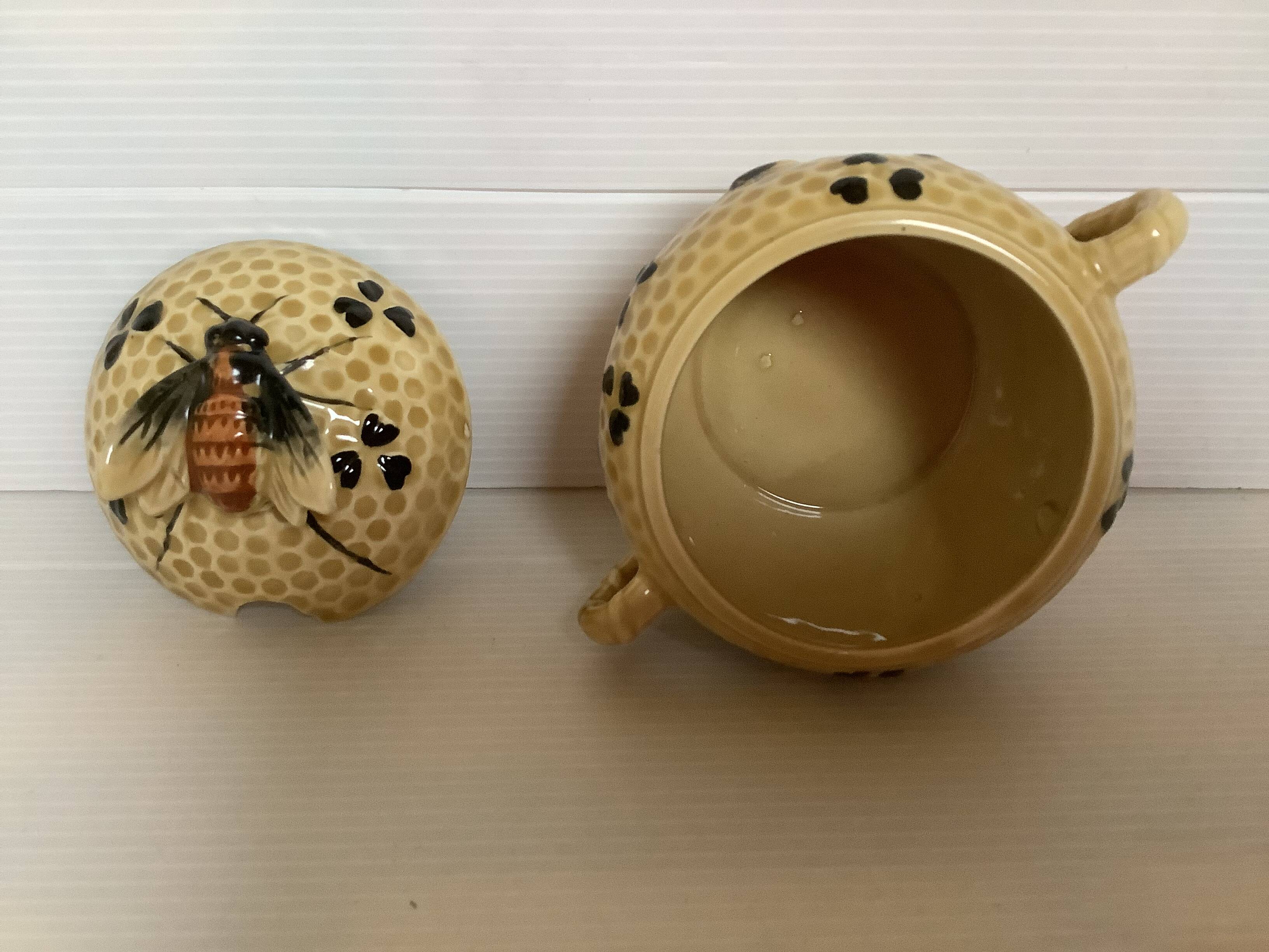 Old honey pot with bee decoration