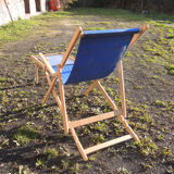 Old sunbathing in wooden & blue fabric