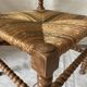 Corner chair in straw and turned wood, fireside chair.