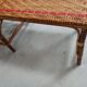 Sunbathing sunbathing in wicker rattan wood deckchair red lounger