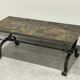 Brutalist-style coffee table made of mixed wrought iron and stone.