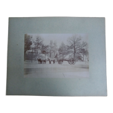 Old photograph from 1900 of a carriage, coachman, and horses.