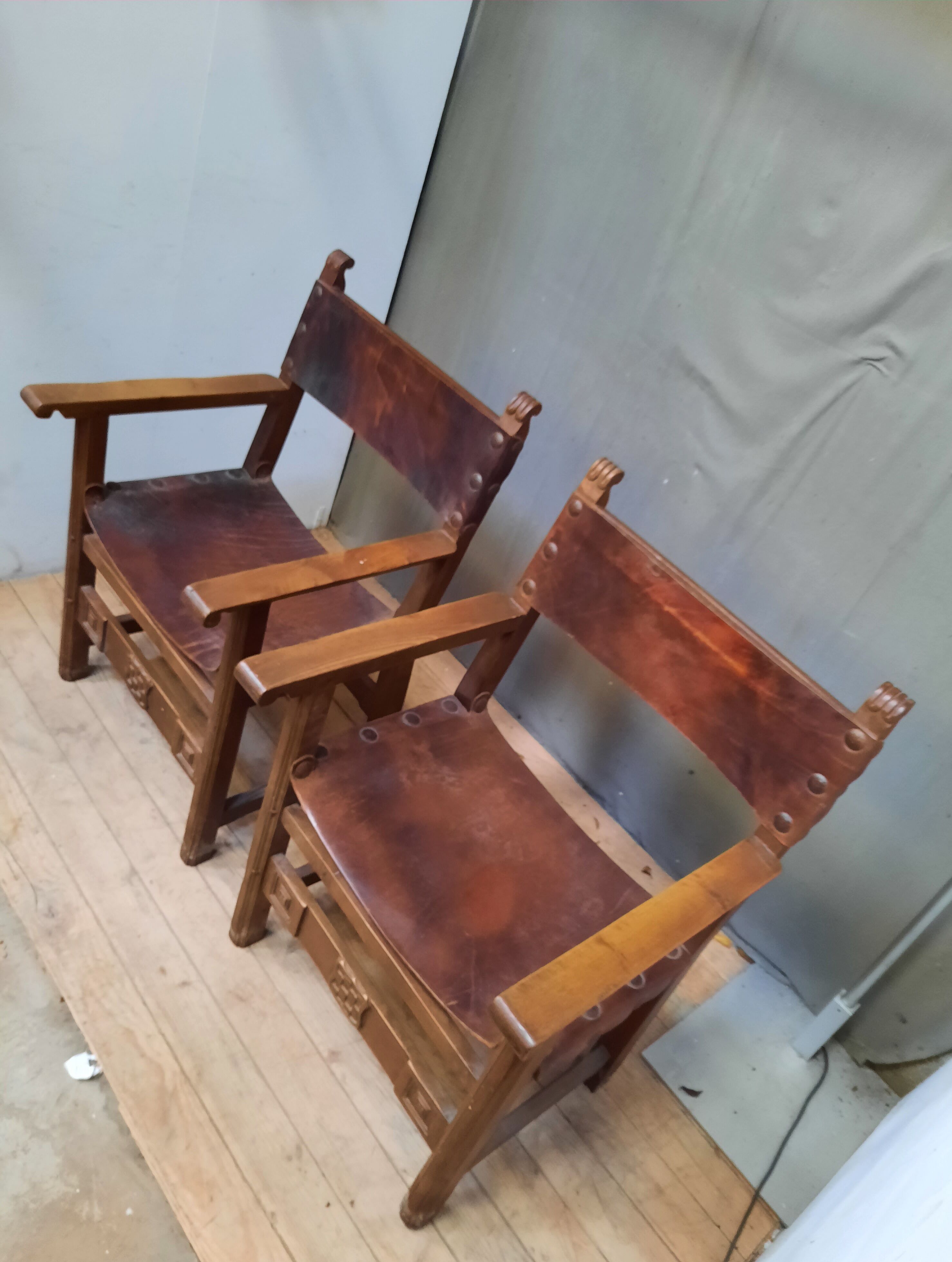 Pair of medieval leather style armchairs
