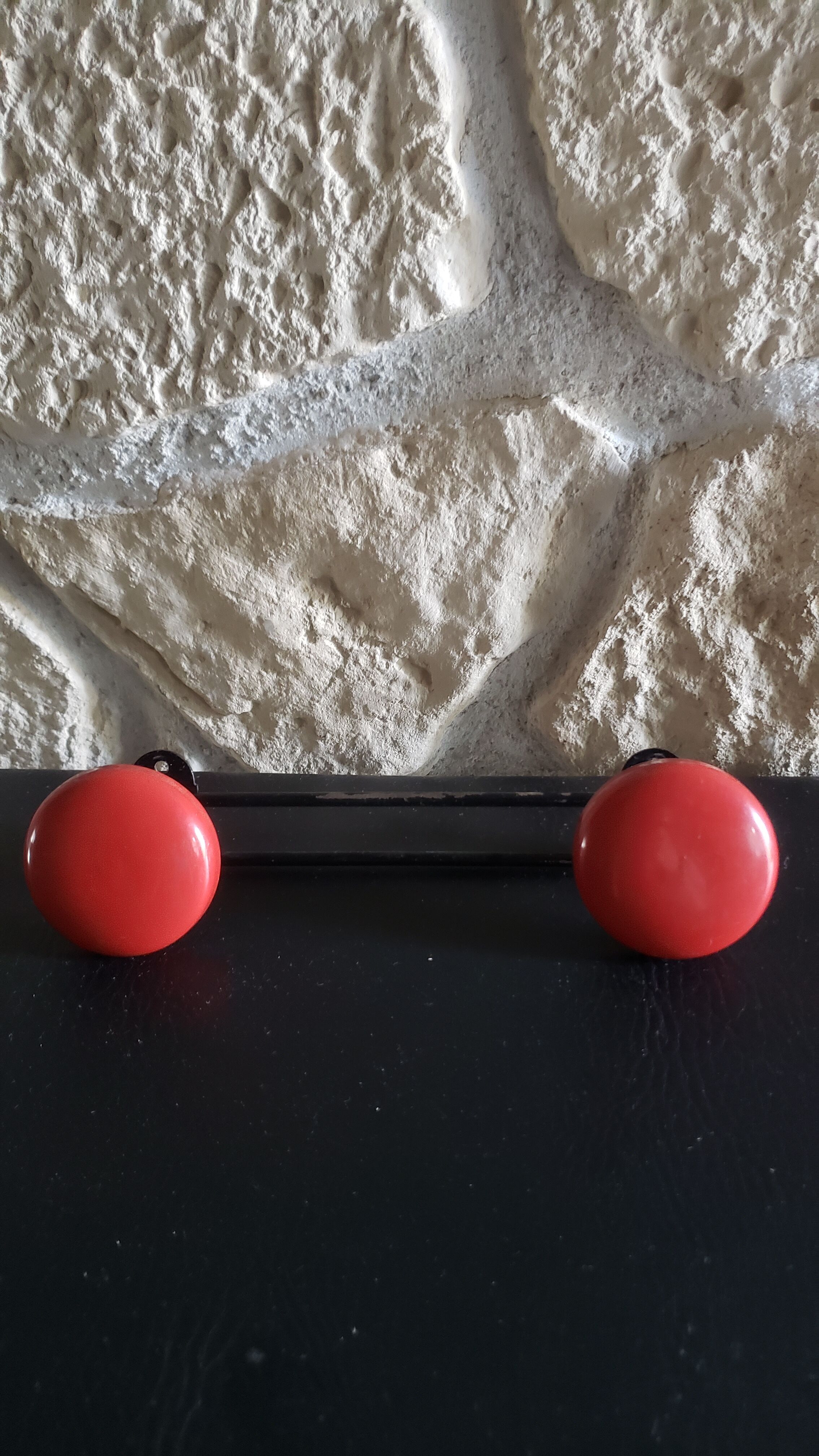 Metal coat rack with 2 red hooks