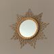 Mirror sun in braided rattan.