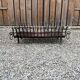 Vintage cast iron fireplace cradle with 16 bars.
