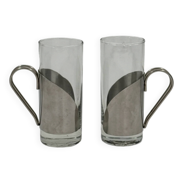 Pair of large vintage glass glasses with a metal sleeve and wire handle.
