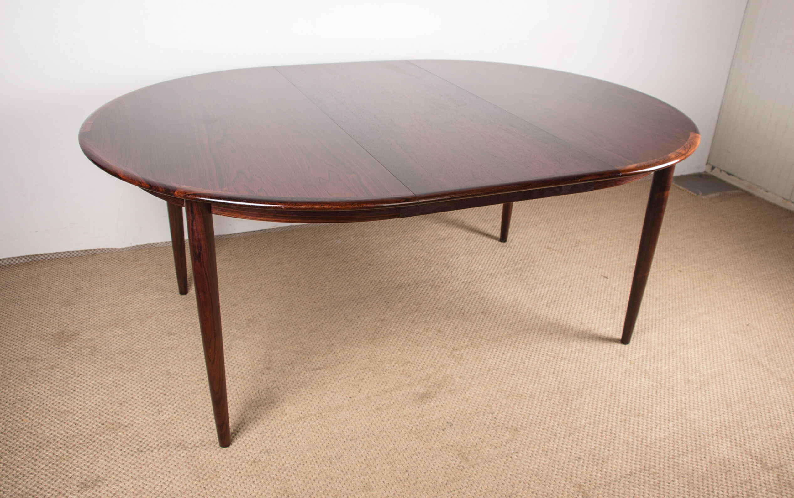 Danish extendable dining table in Rio Rosewood model 55 by Arne Vodder for Sibast 1958.