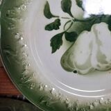 Antique earthenware plates with fruit decoration.