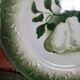 Antique earthenware plates with fruit decoration.