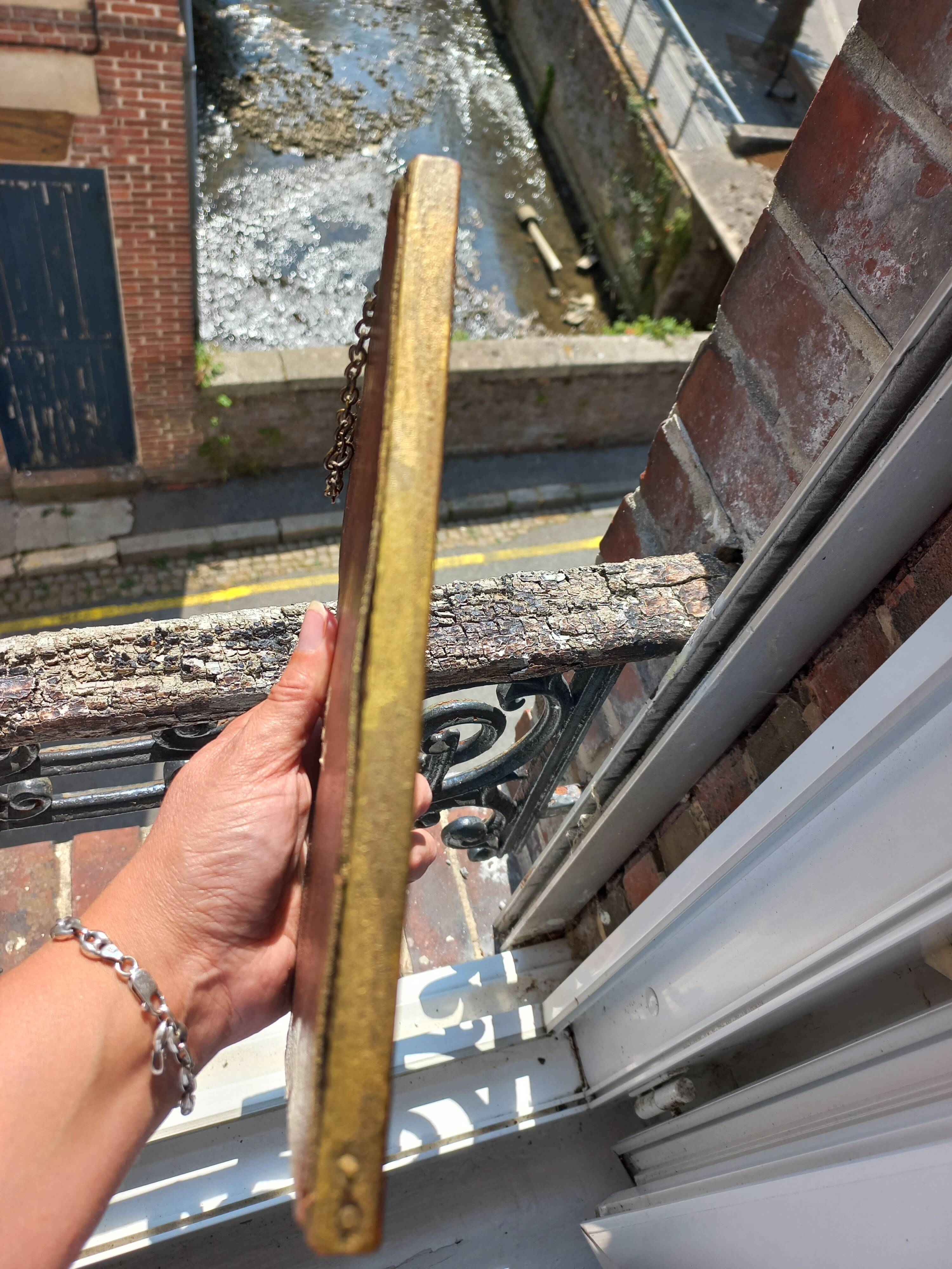 Small vintage mirror in gilded wood, bevelled glass with chain.
