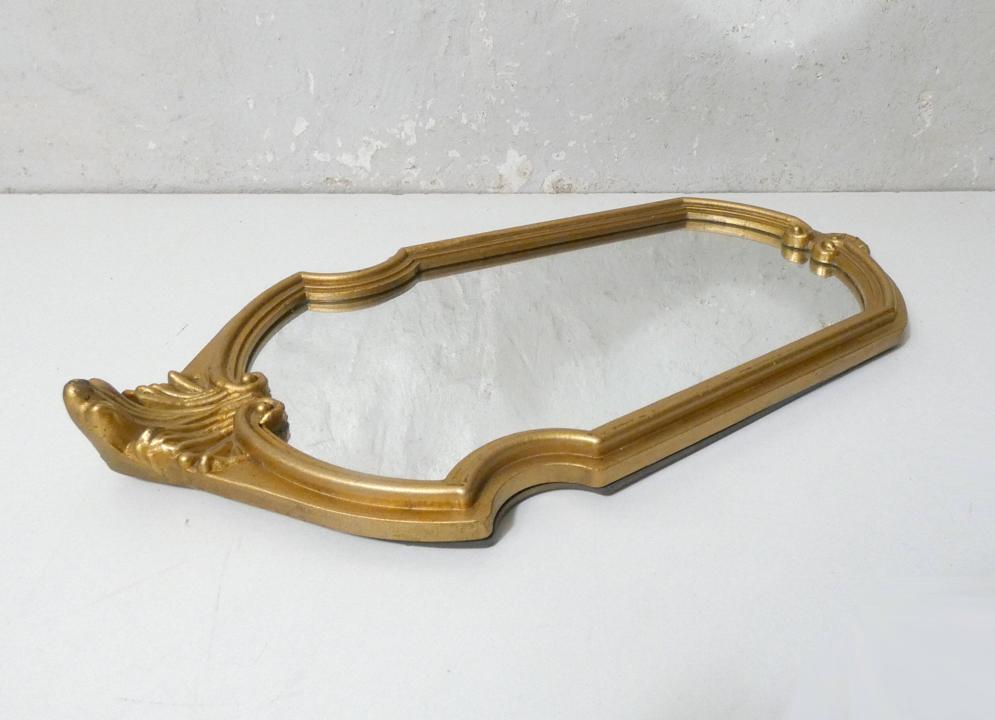 Antique Louis XV style mirror with a vintage carved gold frame.