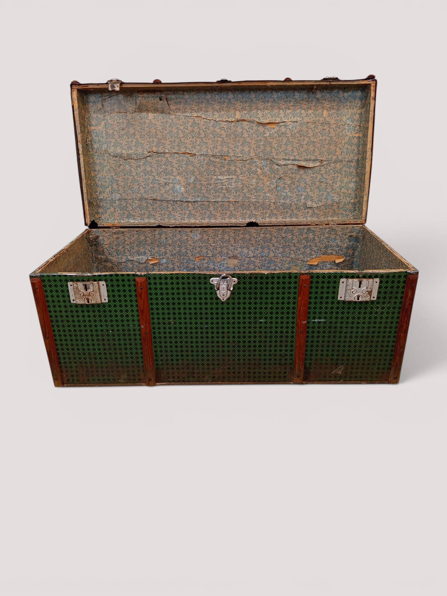 Vintage wooden and metal green travel trunk, circa 1930.
