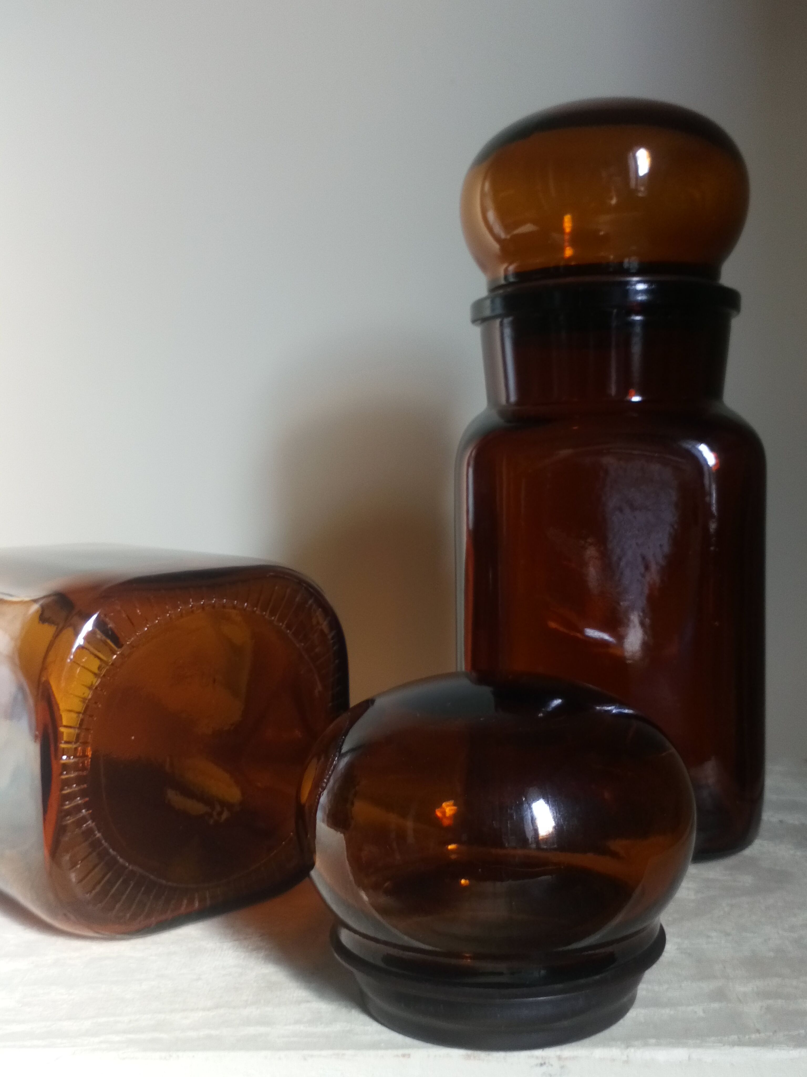 Duo of vintage apothecary bottles in amber glass