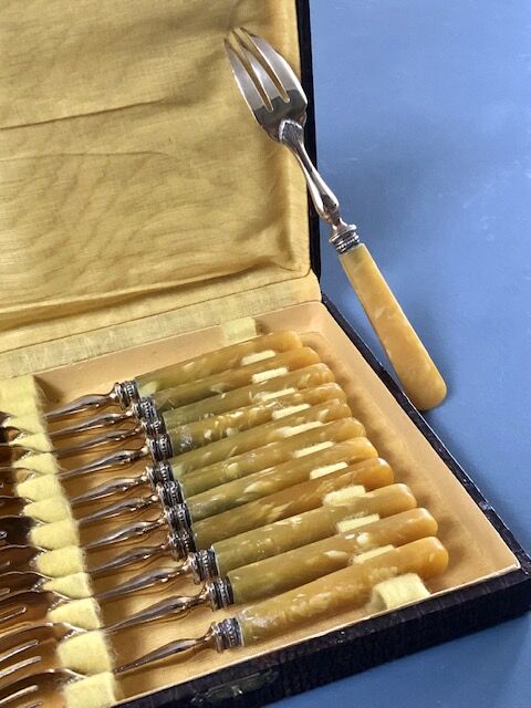 Brass and yellow galathite cake forks