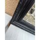 Black lacquered wood mirror "originally punctured"