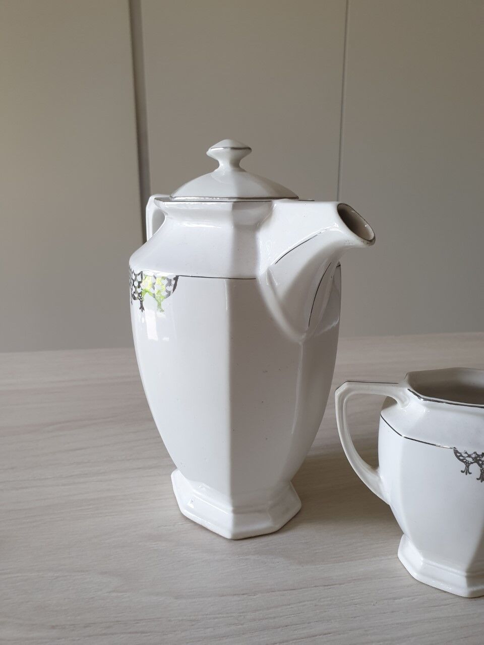 Old coffee maker and its milk pot