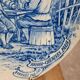 Old advertising plate with blue decoration after Teniers – 100,000 Shirts Paris