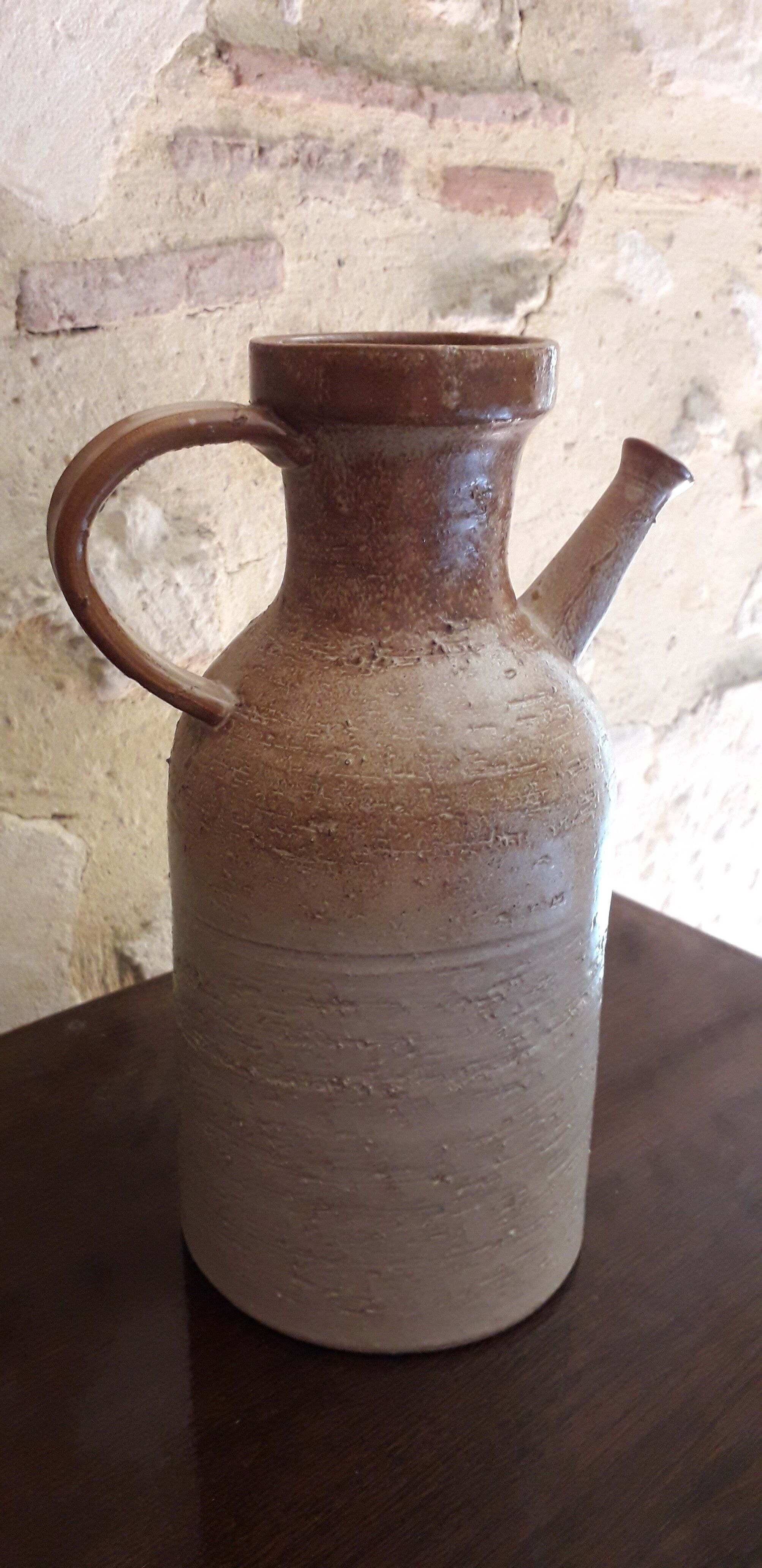 Vintage kid jug in two-tone sandstone with a handle and spout