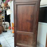 Bonnetière man standing cabinet a door