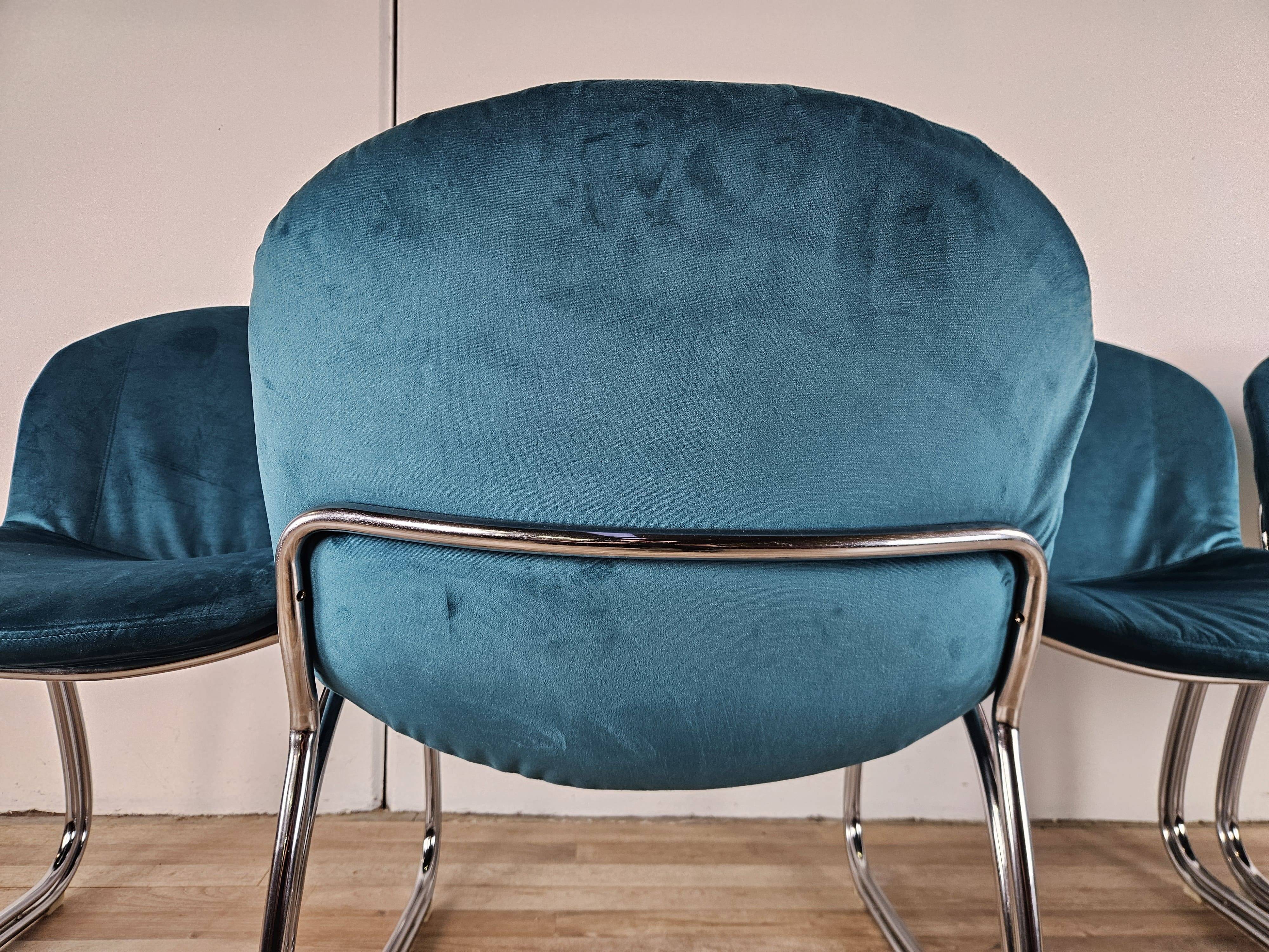 Four 1970s tubular chairs upholstered in blue velvet