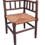 Old corner straw armchair in turned wood