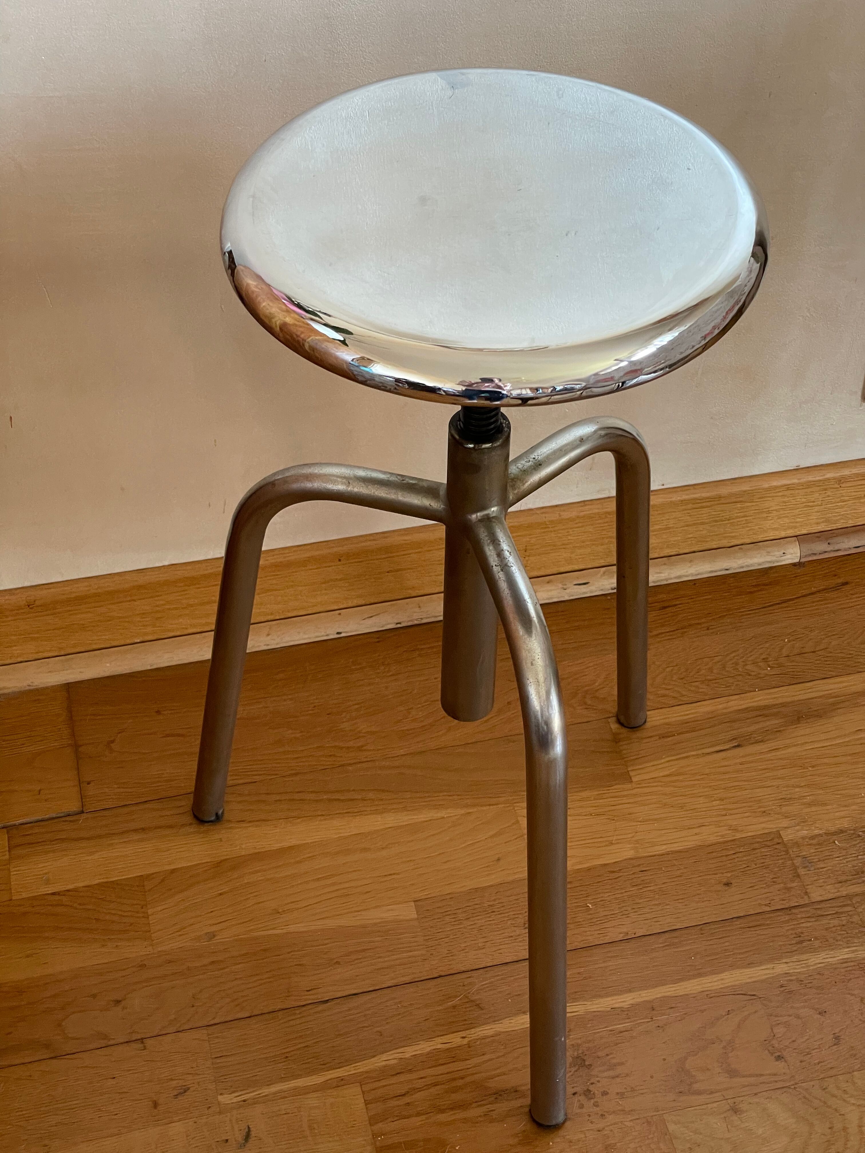 Chrome screw stool of hairdresser workshop