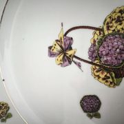 Round porcelain plate from Limoges with a hydrangea basket design.