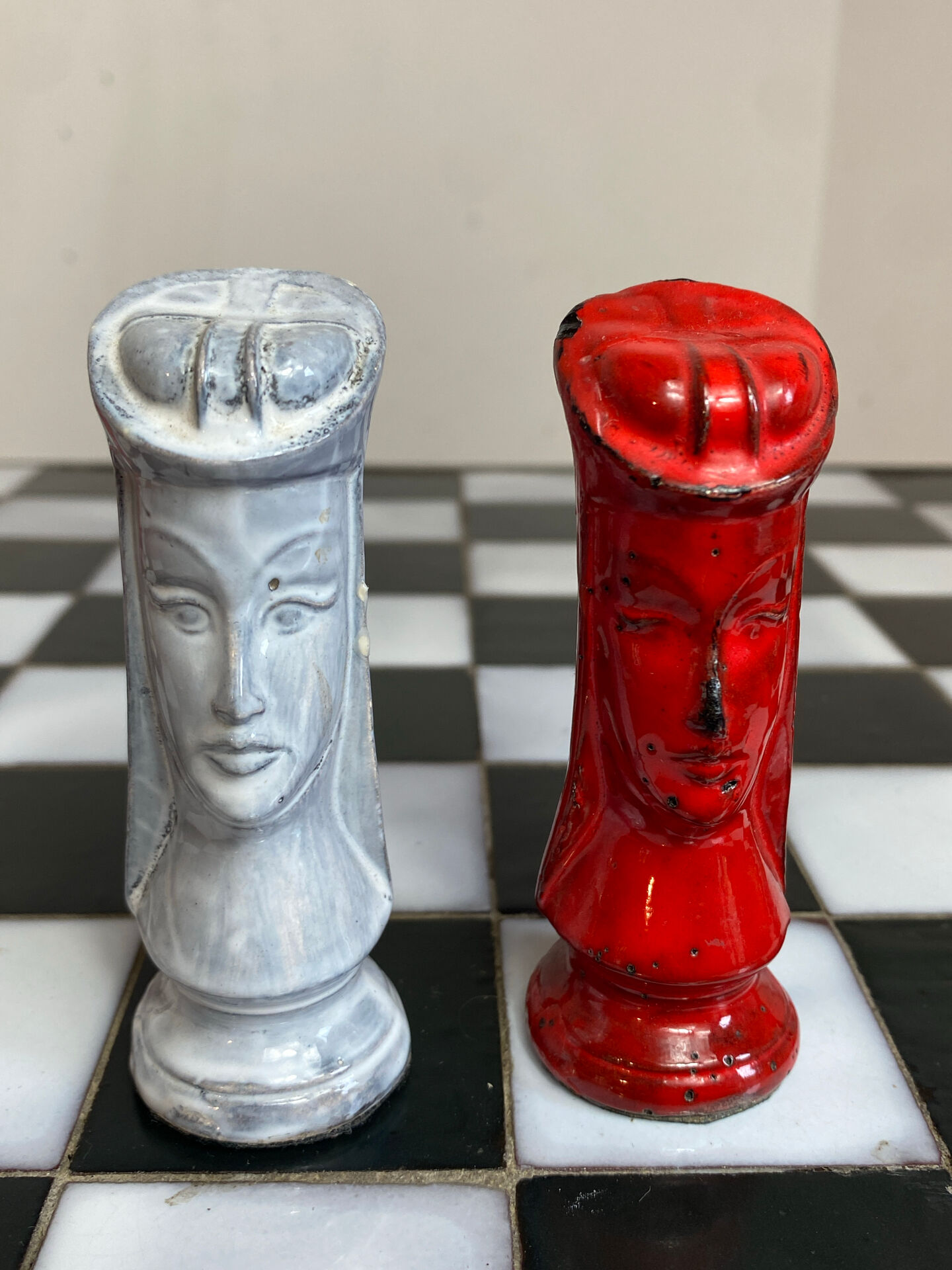 Chess set with ceramic board and pieces.