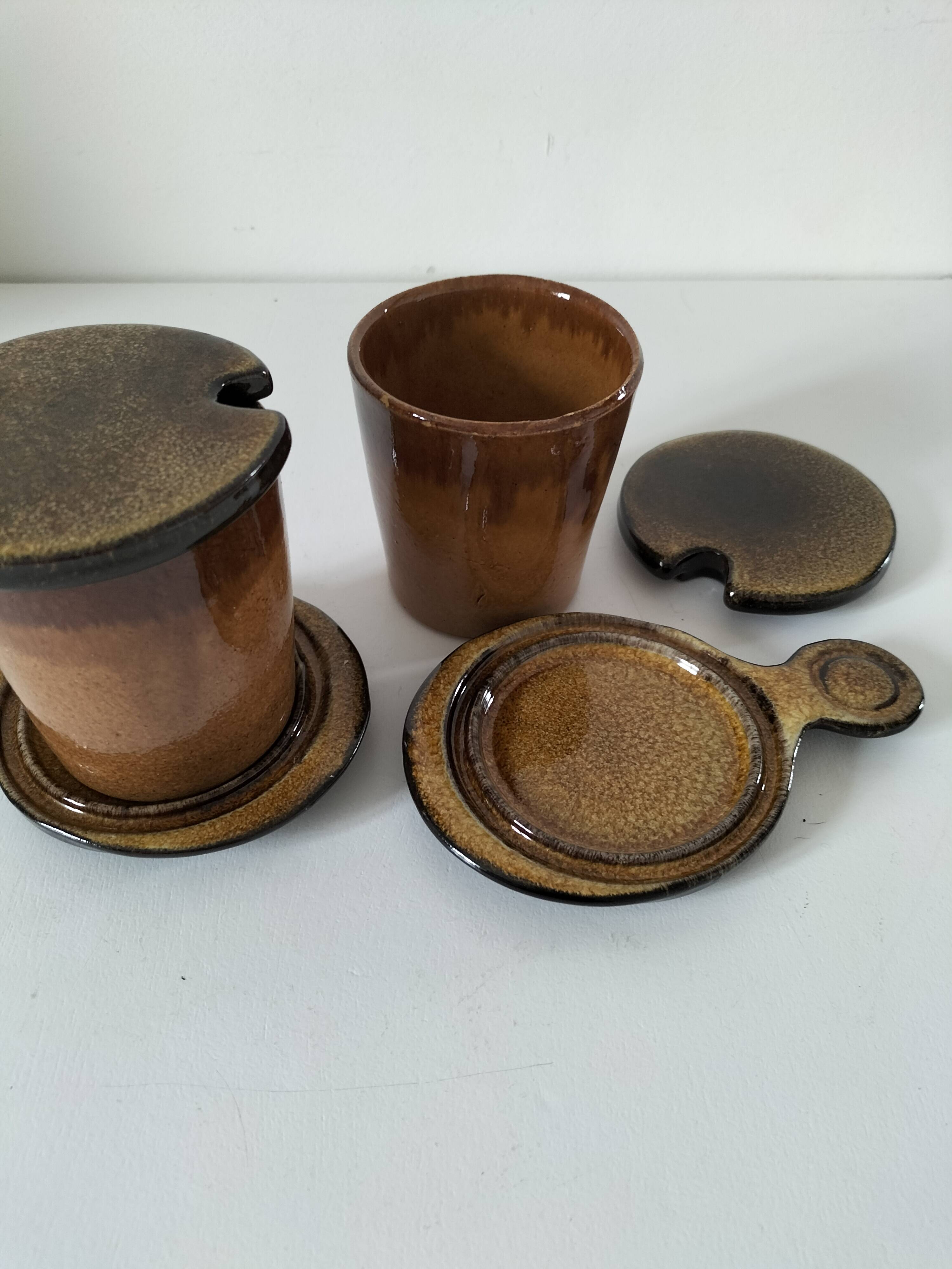 Pair of glazed stoneware cups with saucers and lids