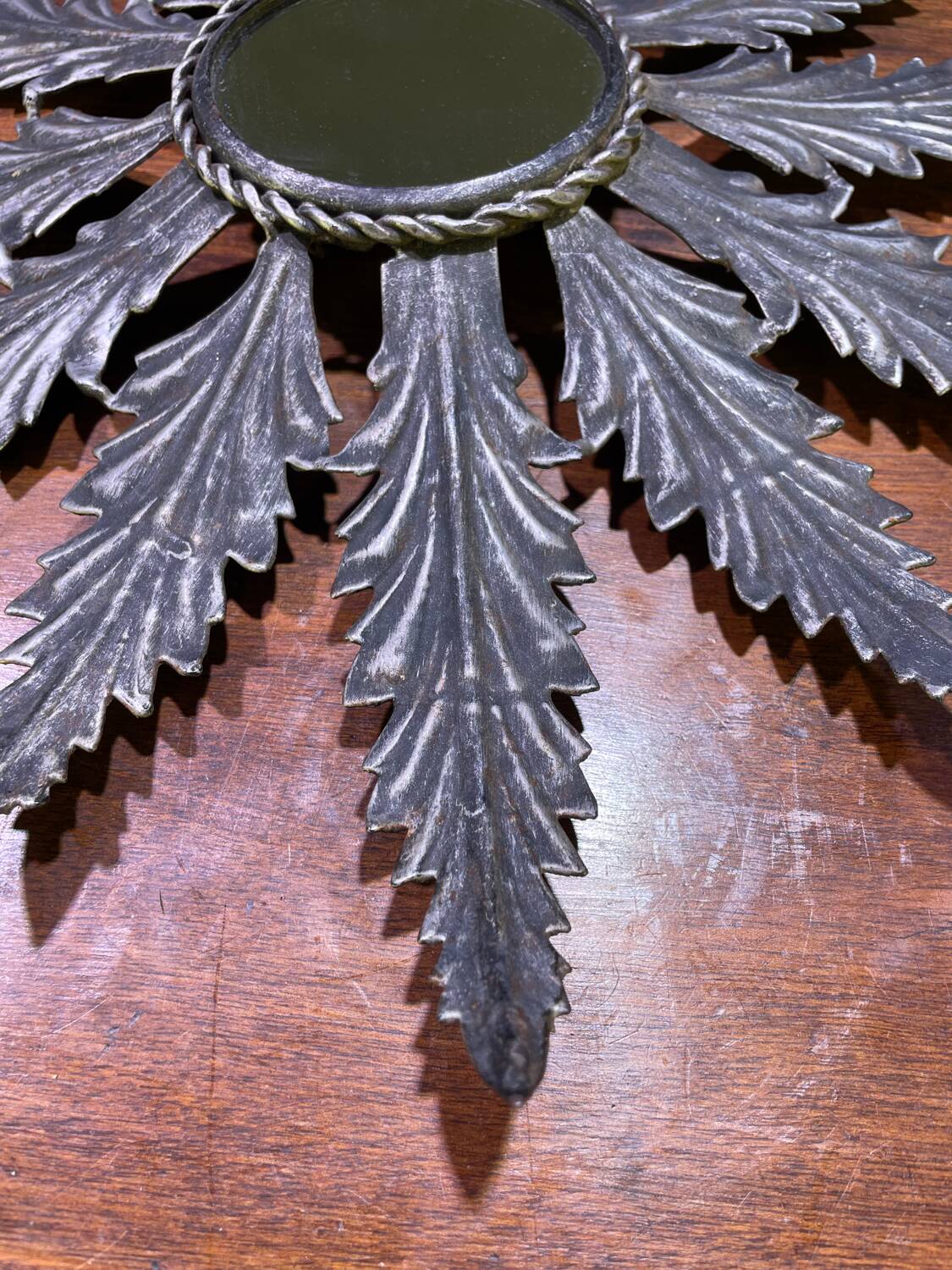 Metal mirror with foliage decoration