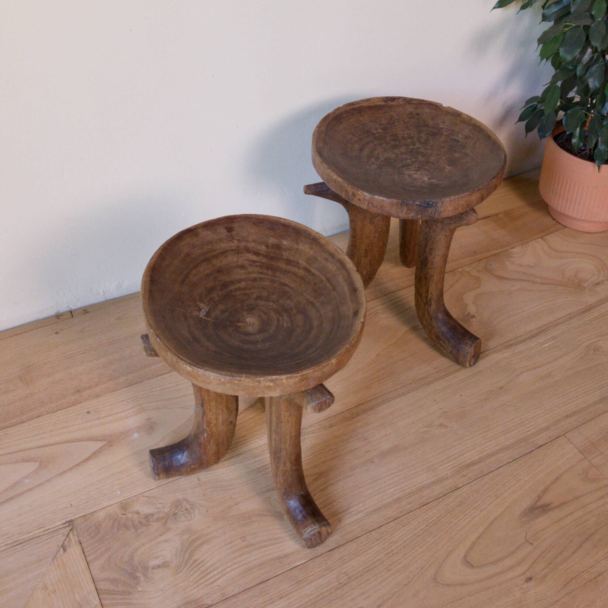 Pair of ancient Ethiopian tripod stools made of monoxyle wood.