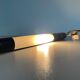 Minimalist black metal wall light with a cylindrical design, 1960s, Germany.